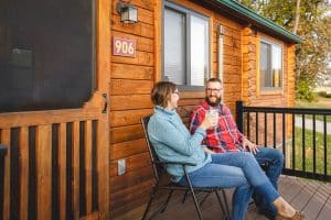 Couple sitting on deck of Country Acres cabin